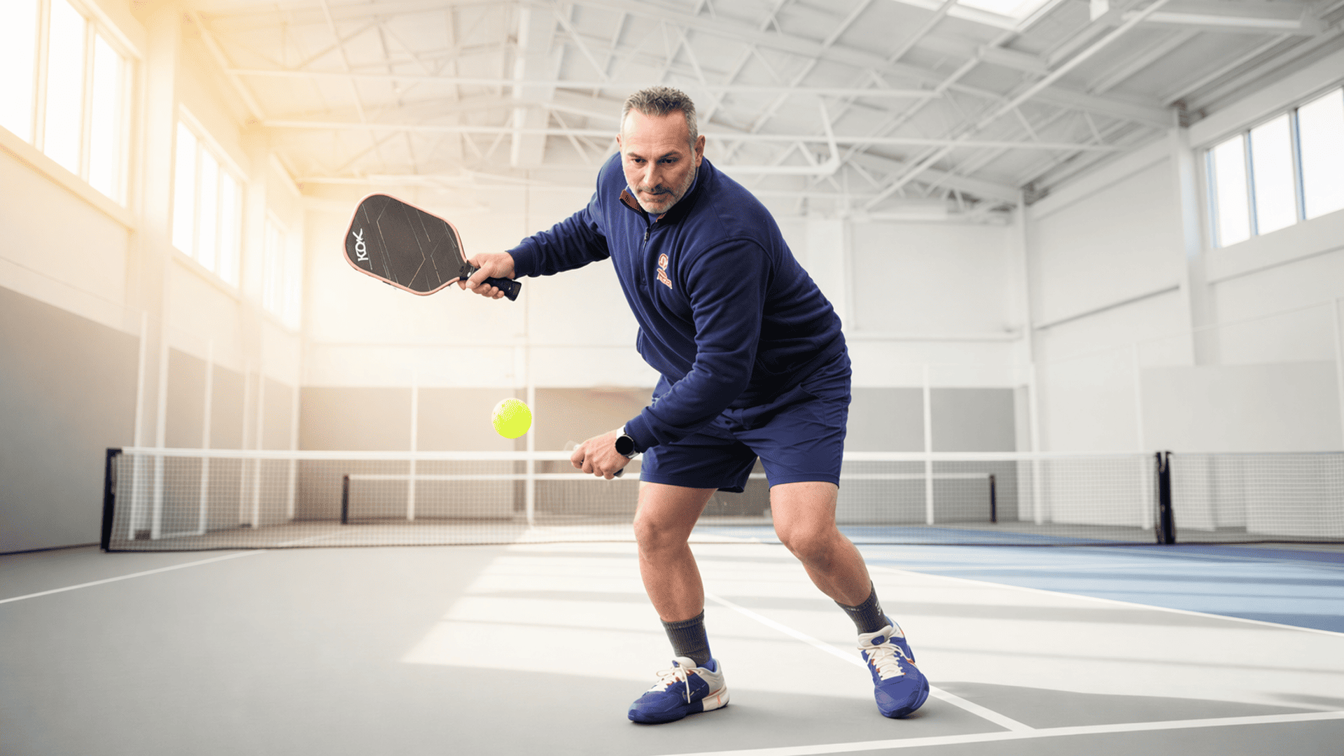KDV competitor playing pickleball on an indoor court